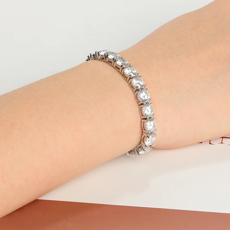 Moissanite bracelet on a wrist against a neutral background