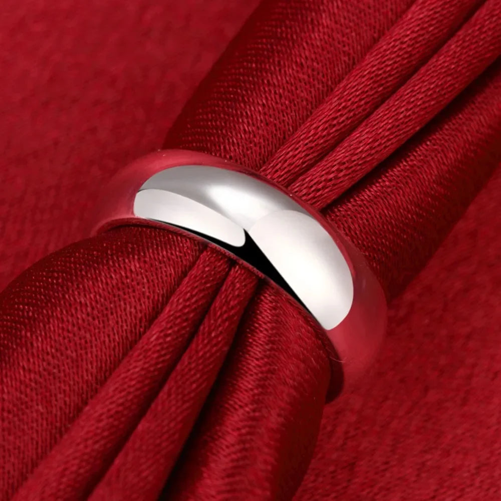 Silver ring on a red fabric background