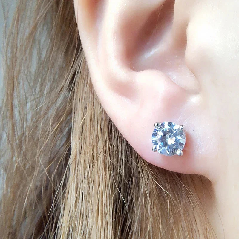 Close-up of an ear wearing a moissanite stud earring with blonde hair
