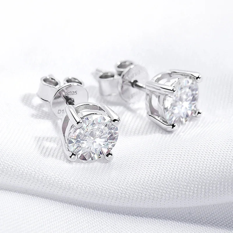 Pair of silver stud earrings with moissanite stones on a white background