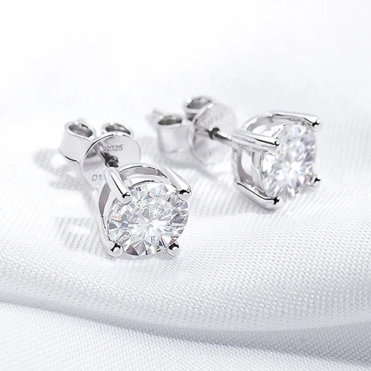 Pair of silver stud earrings with moissanite stones on a white background